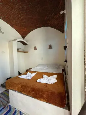 a bedroom with a bed with two towels on it at Nubian King in Aswan