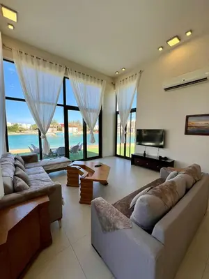 a living room with two couches and a television at tawila t1-17 -5 bed room big villa in Hurghada