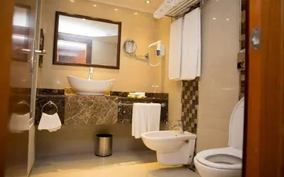 a bathroom with a toilet and a sink at Cleopatra Nile Cruise in Luxor