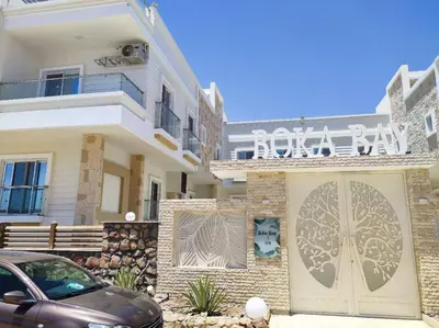 a white building with a sign on the front of it at Boka Bay One in Hurghada