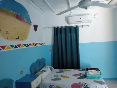 a bedroom with a bed and a ceiling fan at Sabaha Kato in Aswan