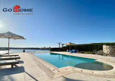 a swimming pool with a bench and an umbrella at Stylish 4BR Villa V15 with a Private Heated Pool at White Villas in Hurghada