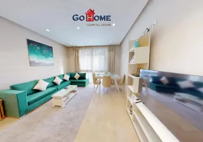 a living room with a green couch and a table at Beautiful 2B. Rooms M7-4B Mangaroveey in Hurghada