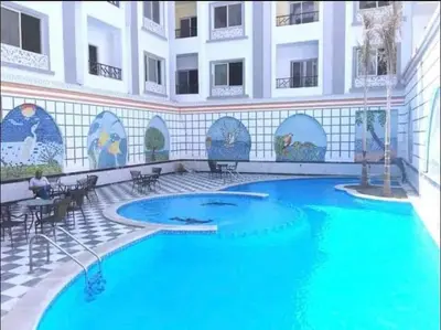 a large swimming pool in the middle of a building at شقة ٢ غرفة in Hurghada