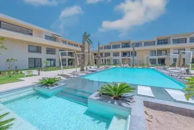 a large swimming pool in front of a building at Ground Floor Studio - G Cribs -Elgouna in Hurghada