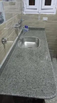 a granite counter top with a sink in a kitchen at Ikea flat 4 in Hurghada