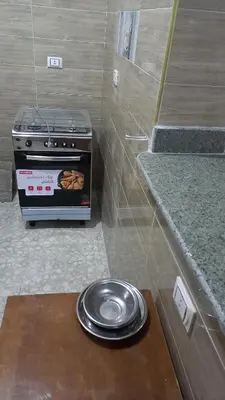 a stove in a kitchen with a plate of food at Ikea flat 4 in Hurghada