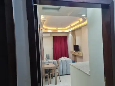 a view of a living room with a table and a couch at Hurghada Appartment front of dream beach in Hurghada