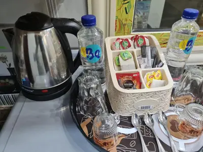 a counter with a coffee maker and bottles of water at Hurghada appartment one room front of dream beach in Hurghada