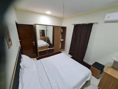 a small room with a bed and a mirror at Hurghada appartment one room front of dream beach in Hurghada