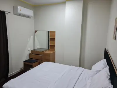a bedroom with a bed and a dresser and a mirror at Hurghada appartment one room front of dream beach in Hurghada