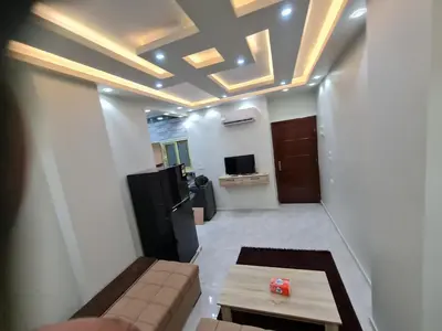 a living room with a couch and a table at Hurghada appartment one room front of dream beach in Hurghada