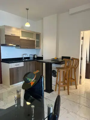 a kitchen with a table and chairs in a room at My Sky Sea View 1 Bedroom Apartment in Hurghada