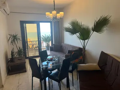 a living room with a table and a couch at My Sky Sea View 1 Bedroom Apartment in Hurghada