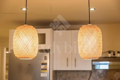 two pendant lights hanging from the ceiling in a kitchen at Ladybird - Azzurra Beauty in Hurghada