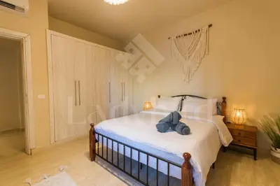 a bedroom with a bed with a teddy bear on it at Ladybird - Azzurra Beauty in Hurghada