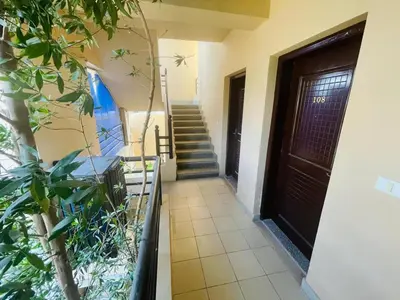 a hallway of a house with a door and stairs at Navy Chalet 108 in Hurghada