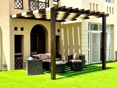 a pergola on the side of a house at Apartment Azzura Sahl Hasheesh with private garden in Hurghada