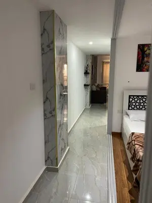 a bedroom with a walk in shower next to a bed at Marina City portghalib one bedroom in Port Ghalib