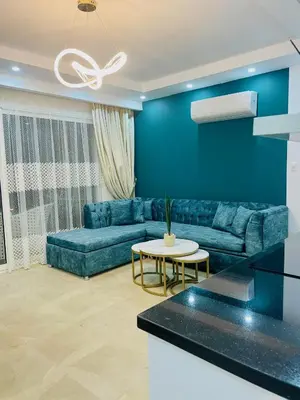 a blue living room with a couch and a table at Selena bay in Hurghada