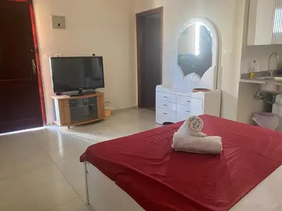 a living room with a tv and a towel at Hurghada- Magawish Studio 3 in Hurghada
