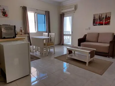 a living room with a couch and a table at Nice Studio in Elegant Compound Intercontinental Area in Hurghada