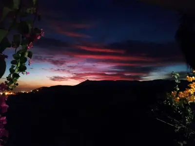 a sunset in the sky with a mountain in the background at Gabawy Garden Doppelzimmer in Luxor