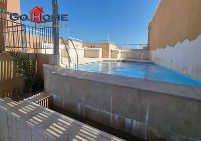 a swimming pool on the side of a building at Pretty 4BR Penthouse MB7 with Private Heated Pool at New Marina in Hurghada