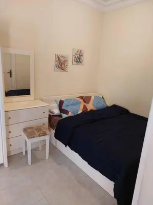 a bedroom with a bed and a dresser and a mirror at Cozy/Comfy Studio at Intercontinental Area in Hurghada