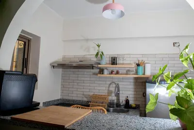 a kitchen with a sink and a counter with a table at Villa Anna & Snake in Hurghada