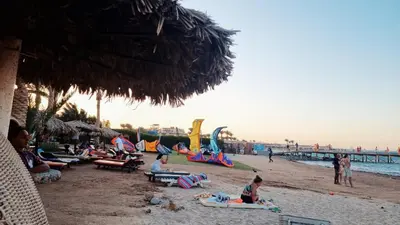 a group of people sitting on the beach at Palma Resort in Hurghada
