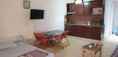a living room with a couch and a table and chairs at Palma Resort in Hurghada